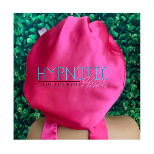 Silk Satin Hair Bonnet in vibrant pink with 'Hypnotic Hair' logo, designed for sleep comfort and hair protection with adjustable fit.