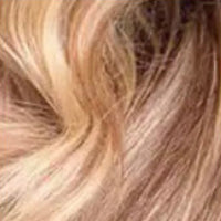 Close-up of blonde and light brown seamless clip-ins showing smooth texture and natural blend. Hypnotic Hair extensions with 7 flat wefts.