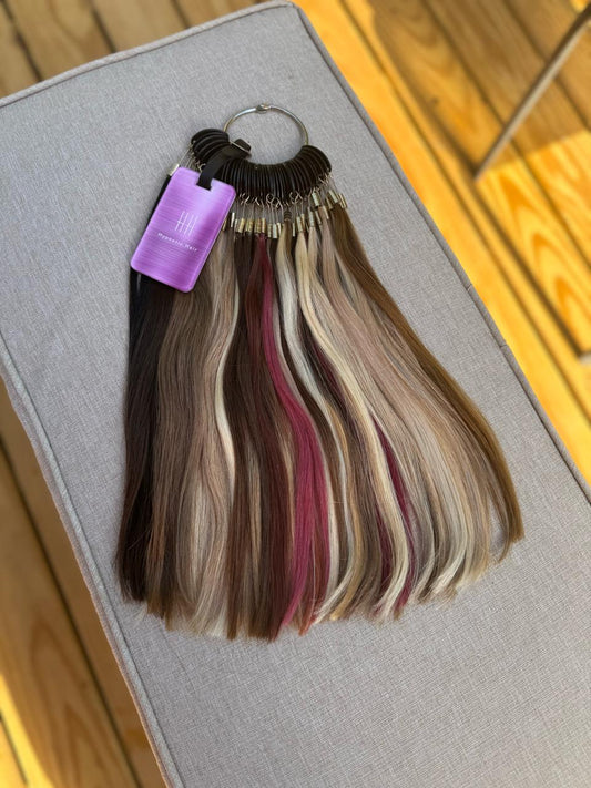 Hypnotic Hair Color Ring – 40 Shades of Perfection featuring a variety of natural and vibrant hair extension swatches on a metal ring. Ideal for selecting custom hairpiece colors.