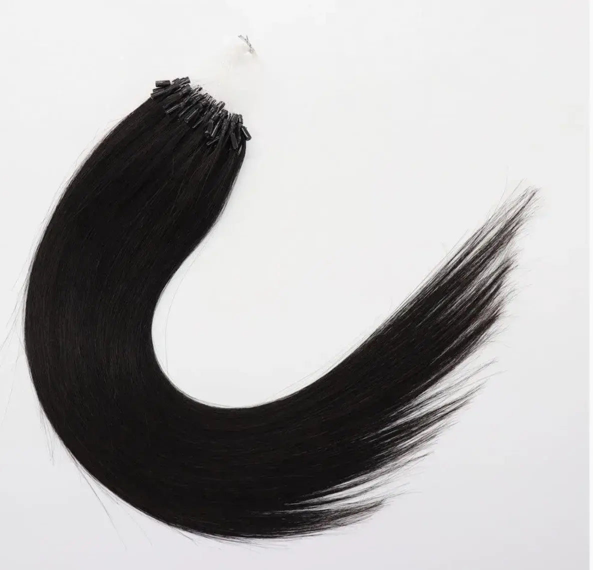 Hypnotic Virgin seamless micro-link hair extensions in sleek black, designed for flexible, long-lasting wear without glue or sewing.