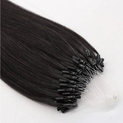 Close-up of black seamless micro-link extensions by Hypnotic Virgin, showing fine attachment tips for a discreet, natural hair blend.
